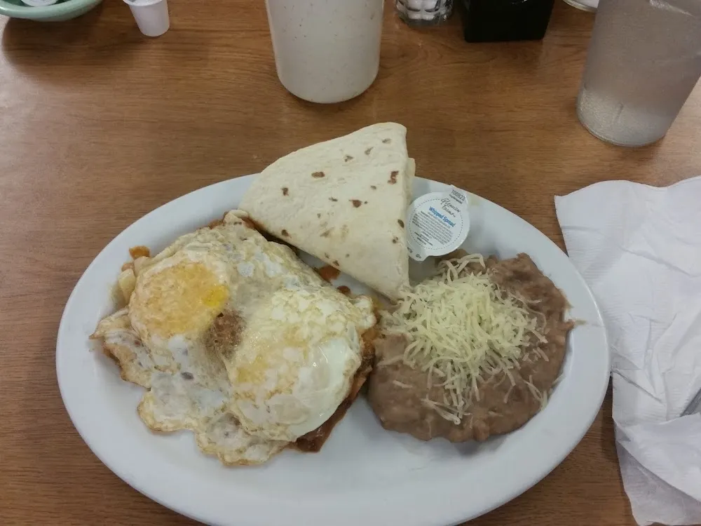 2 Enchiladas 2 Eggs and Refried Beans
